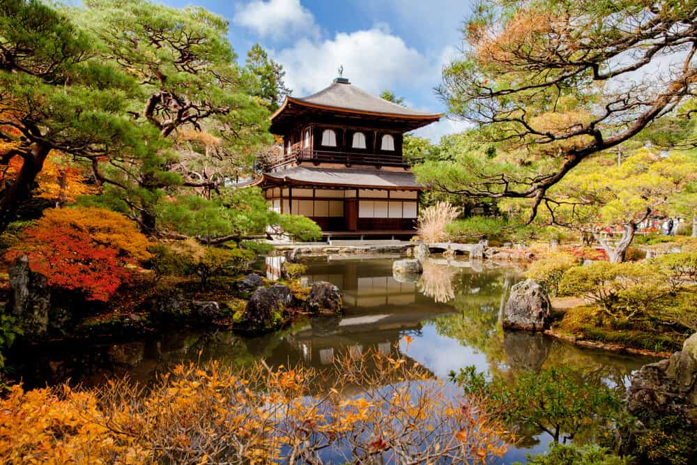 Ginkaku-ji The Silver Pavilion in Kyoto surrounded by trees and pond.