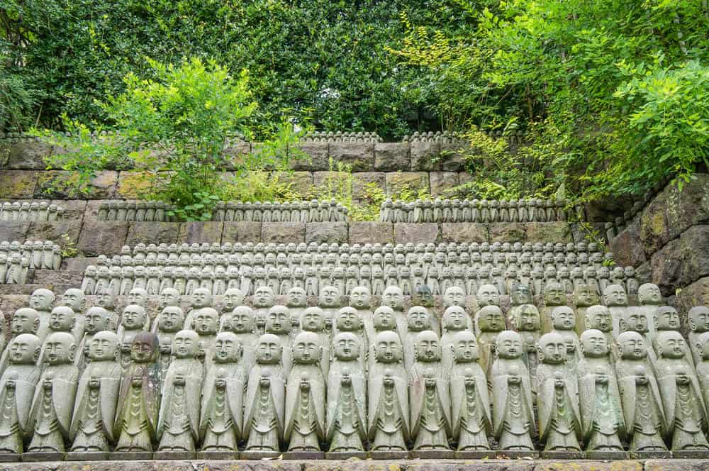 Hase-dera Temple -Jizo Statues lined all all next to each other. There are numerous rows of them.