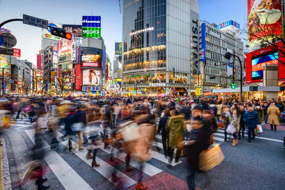 A busy crossing with people blurred walking inShibuya, Japan.