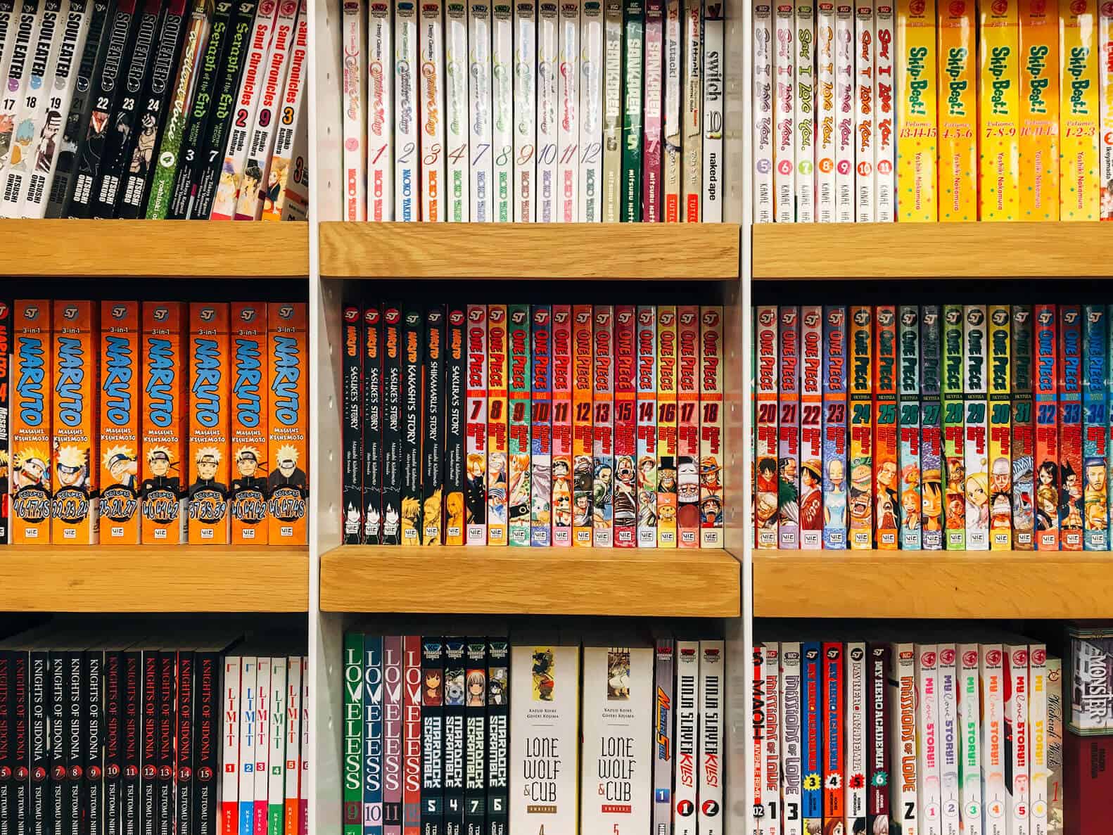A display of a bookshelf with many English manga comic books on display.