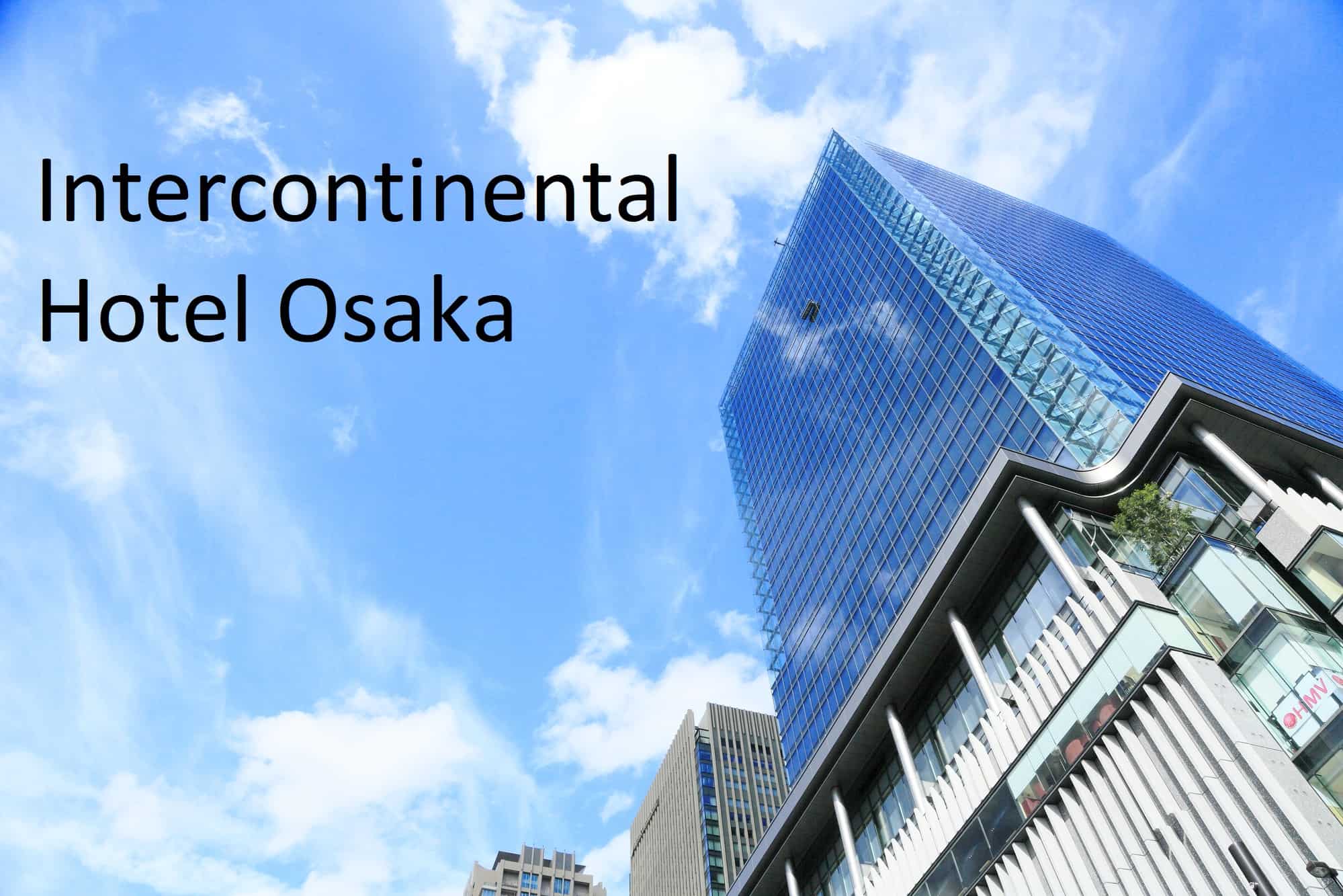 A tall building taken from the bottom looking up. The text on this article reads,"Intercontinental Hotel Osaka."