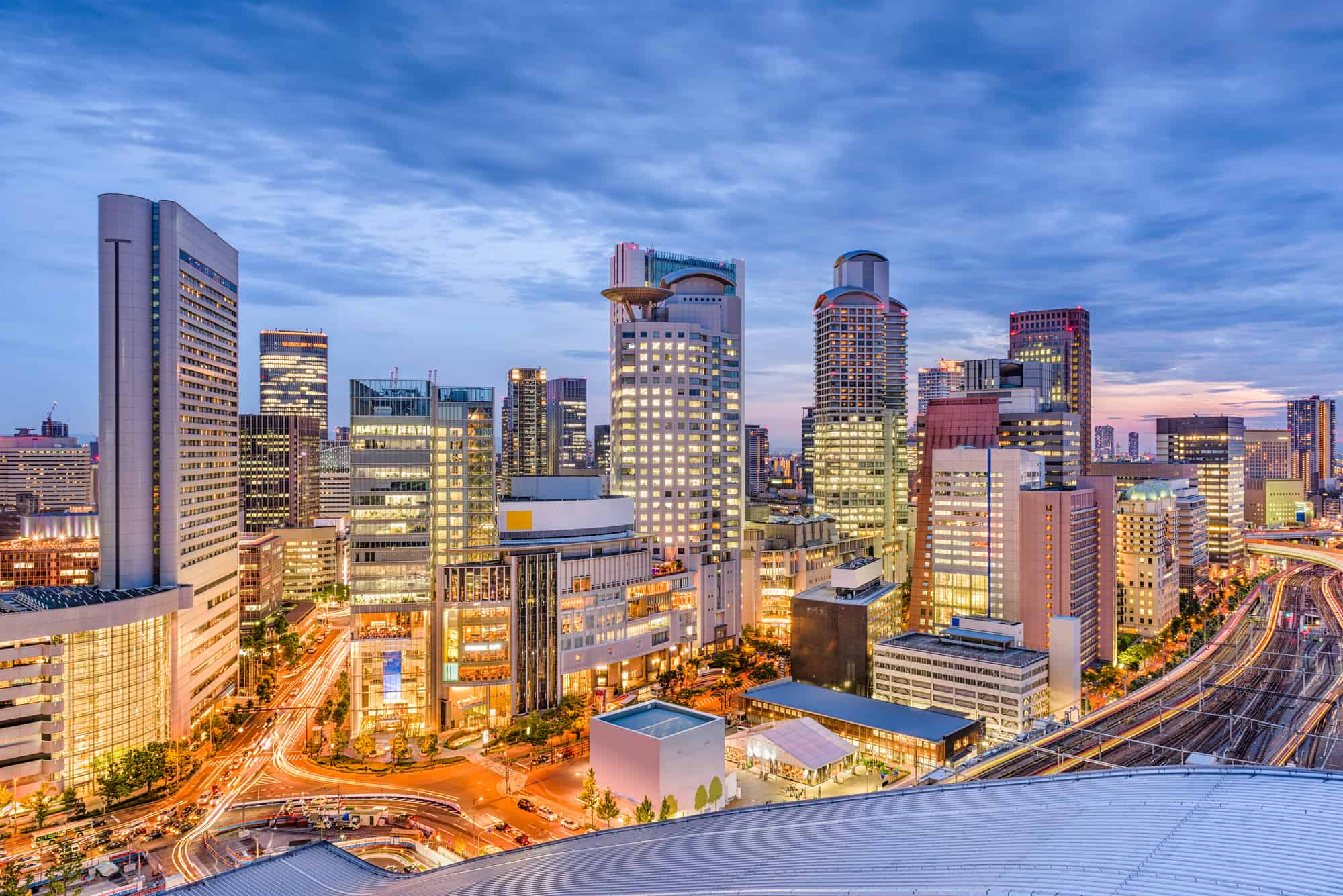 A wide shot of the area around Osaka Station. Many tall buildings and roads can be seen.