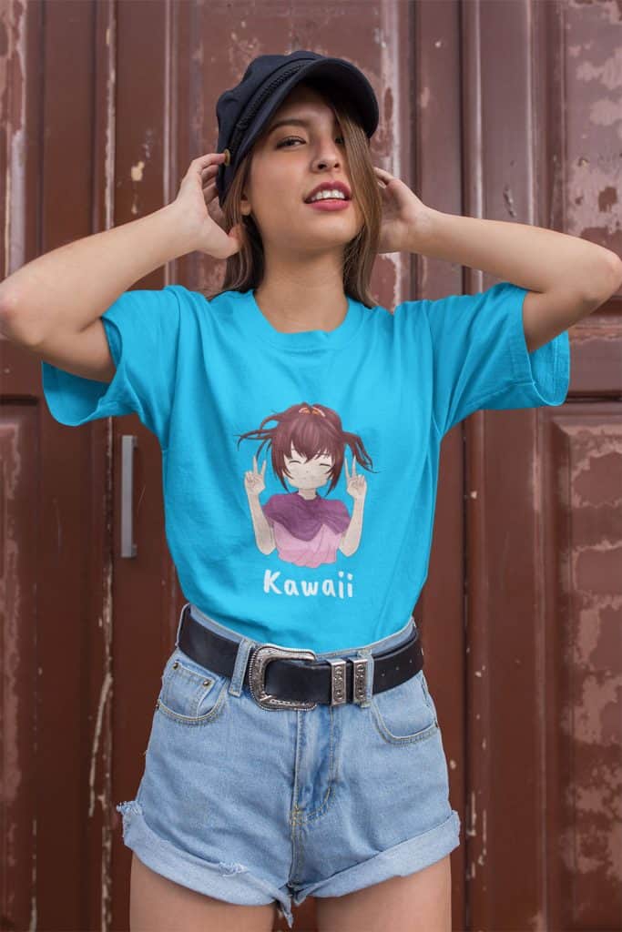 A young woman wearing a blue shirt with a cute girl illustration with the word "Kawaii" on it.