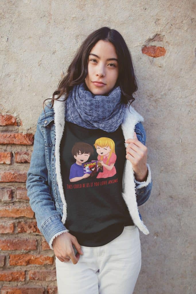 A young woman wearing a black shirt that has an illustration of a boy and girl on it, with text that reads, "This could be us if you love anime."