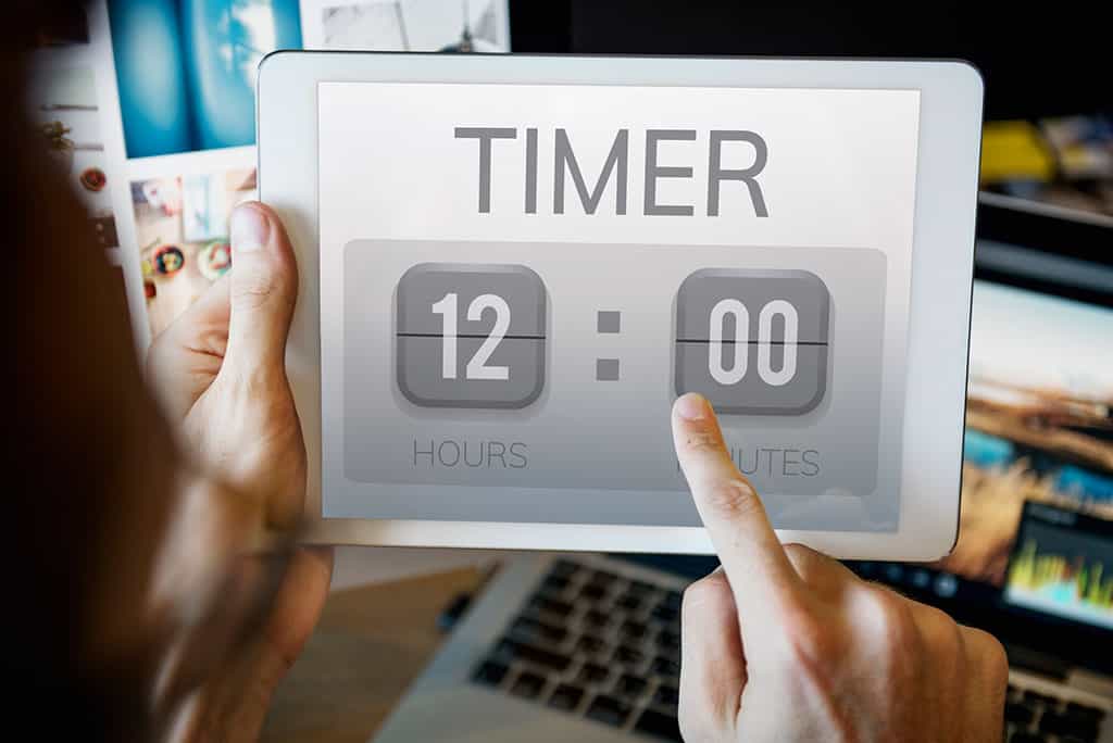 A smart device tablet with the word "TIMER" and 12 hours being displayed on the screen.