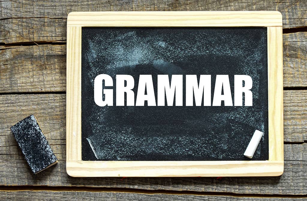 A small blackboard on a table with the word, "GRAMMAR' written on it.