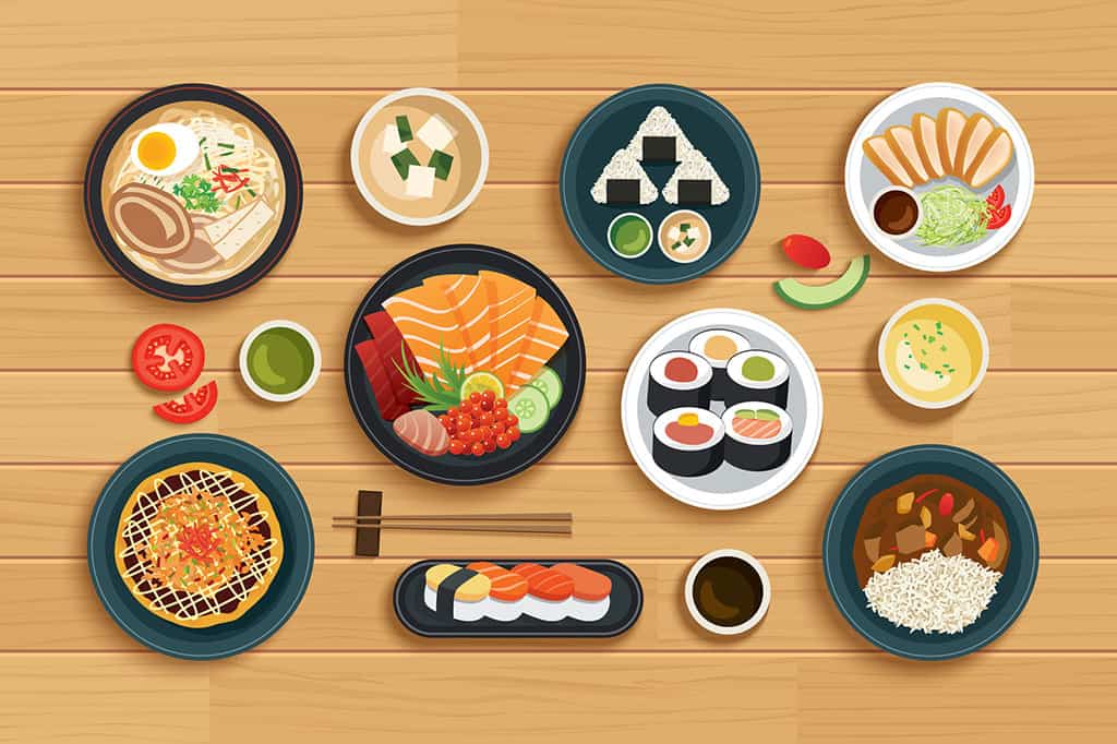 An illustration of Japanese food on plates on a table. There is sashimi, sushi, okonomiyaki, curry and rice, tonkatsu, rice balls, ramen, and soup in bowls with sauces on a table.