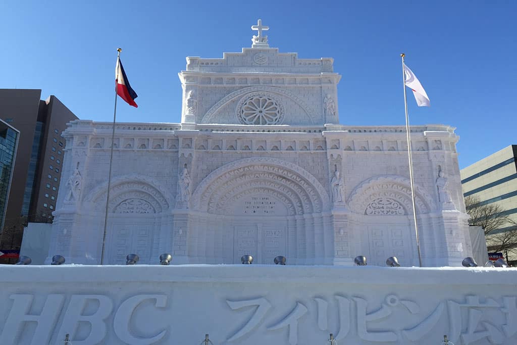 A huge house/church-like structure made out of snow and ice on display at the Sapporo Snow Festival in Hokkaido.